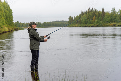 Woman fishing on river