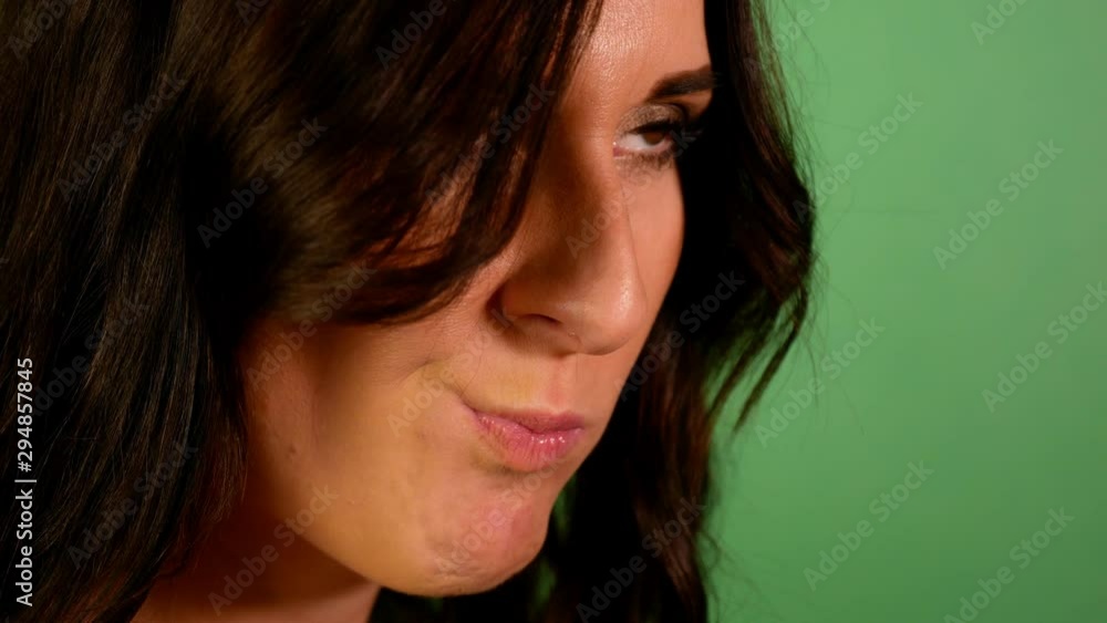 Closeup brunette woman eagerly eating red apple green background. Closeup brunette woman eagerly eating red apple green background.