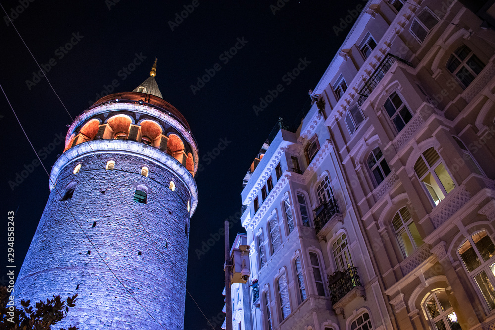 Istanbul, Turkey: night view of the Galata Tower, medieval stone tower built by Genoese in 1348 in the Karakoy quarter, cone-capped cylinder dominating the skyline with panoramic vista of the city