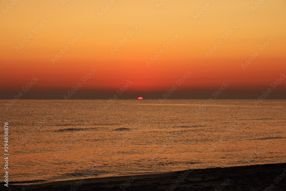 Orange sunrise on the beach