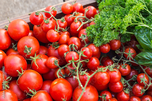 Cherry tomatoes in old wooden tray.