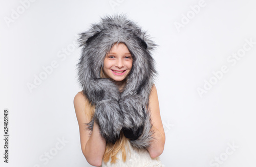 Happy child smile in fashion style. Small girl wear winter hat scarf. Small fashionista. Happy child smile in fashion style. Winter fashion trends for kids. Tips for caring for fur garments