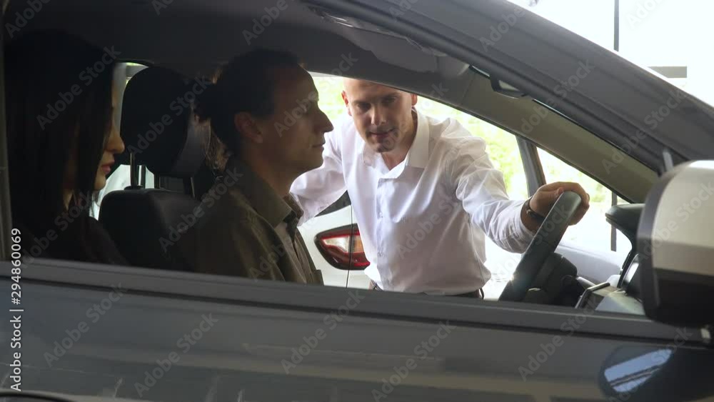 Buyers to sit at the passenger compartment and look around. Seller presents a car Buyers to sit at the passenger compartment and look around. Seller presents a car
