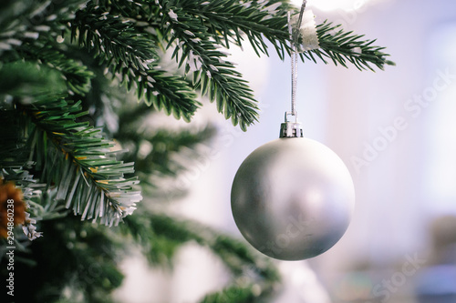Christmas tree branch decorated with silver balls and white decor photo