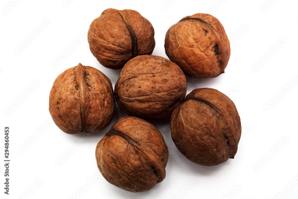 Six walnuts on a white background, close-up Six walnuts on a white background, close-up