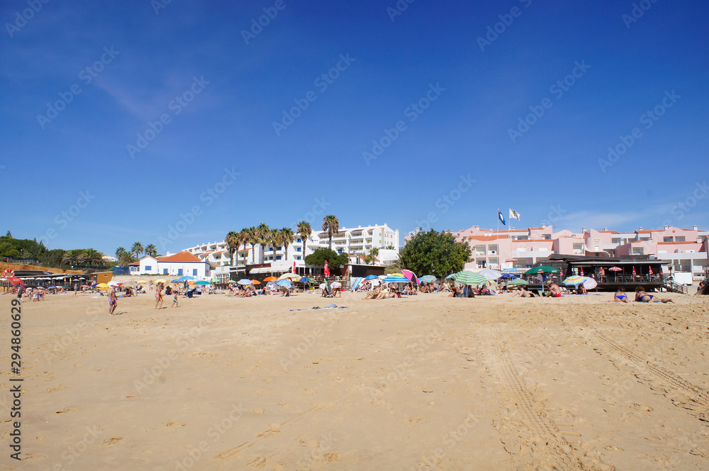 Tourists diving and walking on Vau beach in Portimão, Algarve, Portugal - October 03, 2019.