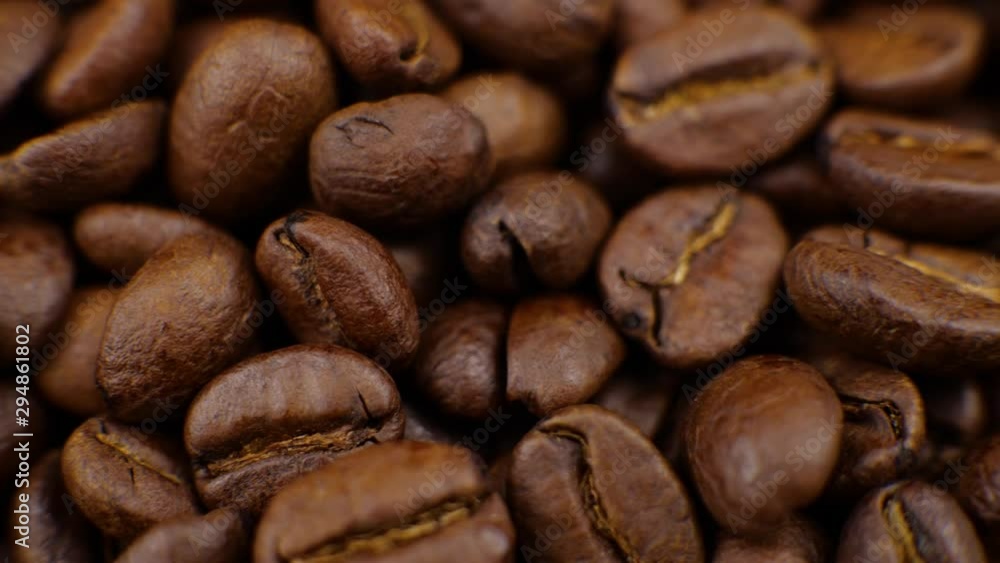Dark Coffee rotating on board Coffee beans clouse up Beautiful coffee beans. Dark Coffee rotating on board Coffee beans clouse up Beautiful coffee beans.