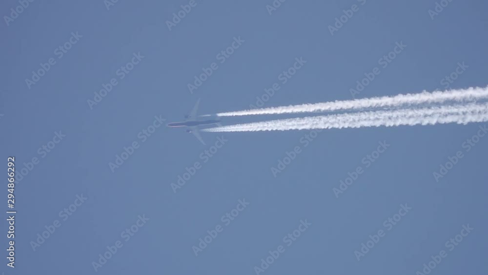 Airplane Flying in Blue Sky with Condensation Trail Airplane Flying in Blue Sky with Condensation Trail