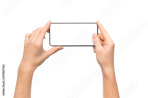 Female hands taking photo on smartphone with blank screen photo