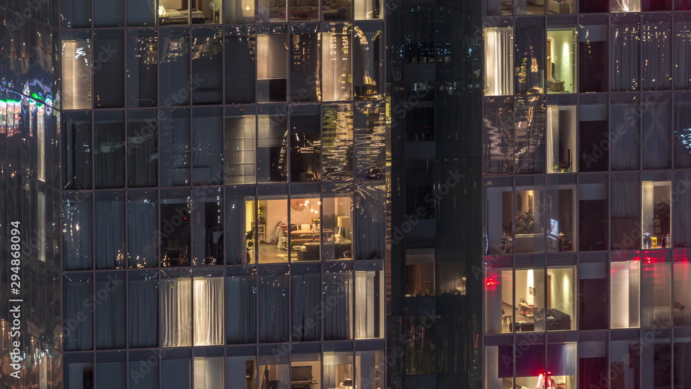 Night view of exterior apartment tower timelapse. High rise skyscraper with blinking lights in windows Night view of exterior apartment tower timelapse. High rise skyscraper with blinking lights in windows