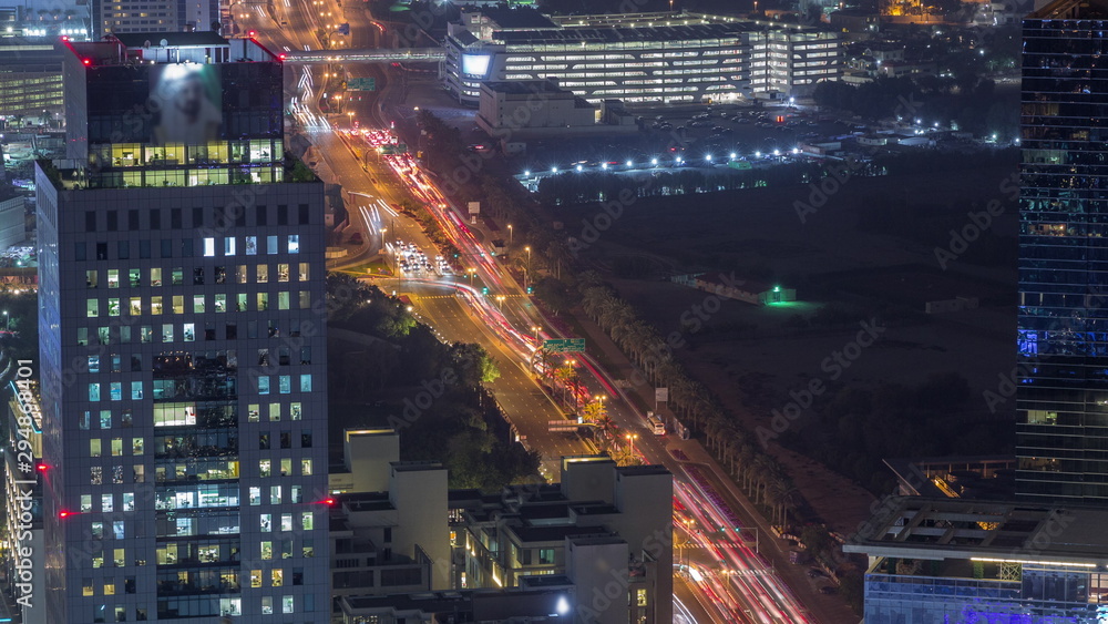 Skyline view of intersection traffic on Al Saada street near DIFC night timelapse in Dubai, UAE. Skyline view of intersection traffic on Al Saada street near DIFC night timelapse in Dubai, UAE.