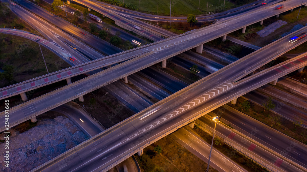Obraz premium aerial view ring road and interchange connecting the city at night