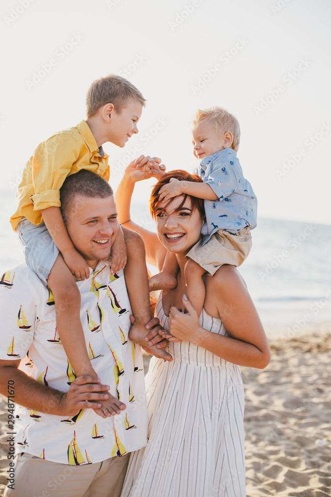Happy family having fun on beach at sunset Happy family having fun on beach at sunset
