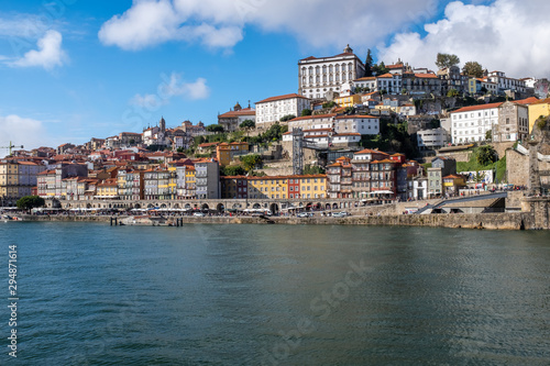 View of Porto across the Douro River from the opposite river bank with historic centre in the distance
