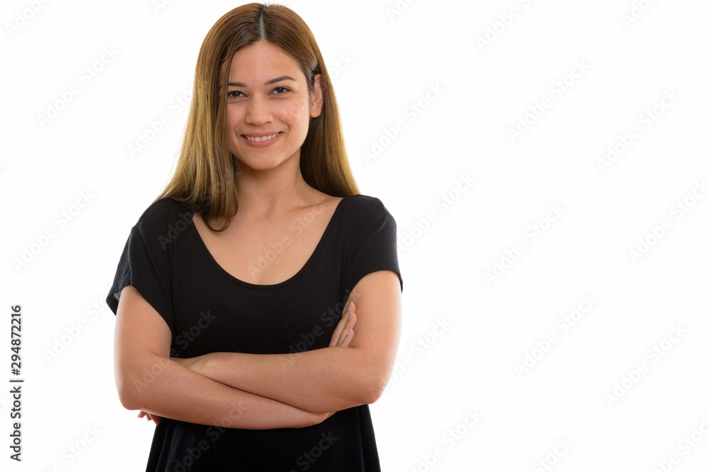 Studio shot of young happy woman smiling with arms crossed Studio shot of young happy woman smiling with arms crossed