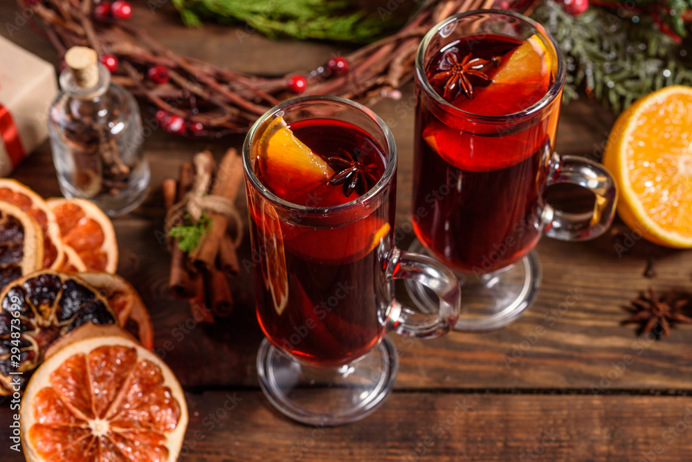 Christmas hot mulled wine with cinnamon cardamom and anise on wooden background Christmas hot mulled wine with cinnamon cardamom and anise on wooden background