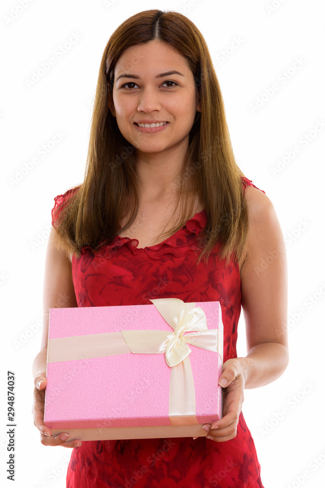 Studio shot of happy young beautiful woman smiling while holding Studio shot of happy young beautiful woman smiling while holding
