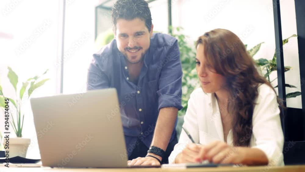 Head of department introducing the new coworker to the system in a hipster shared coworking space. Head of department introducing the new coworker to the system in a hipster shared coworking space.