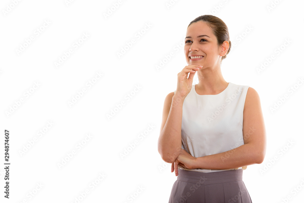 Studio shot of happy young beautiful woman smiling while thinkin Studio shot of happy young beautiful woman smiling while thinkin