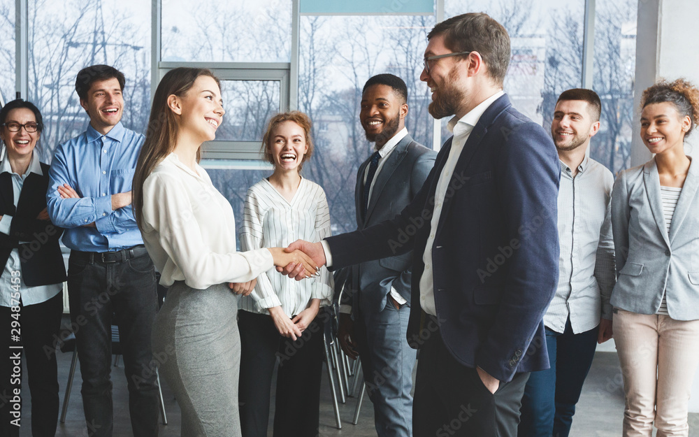 Welcome! Boss and woman shaking hands in office Welcome! Boss and woman shaking hands in office