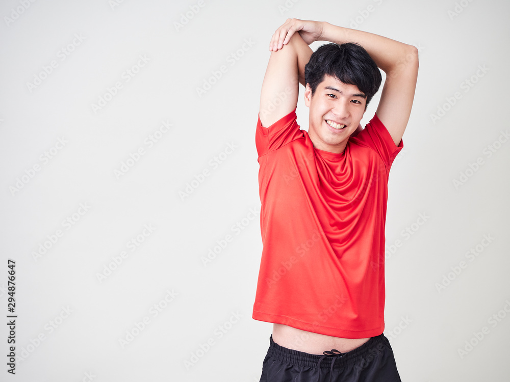 Young man sports player stretching and exercising Young man sports player stretching and exercising