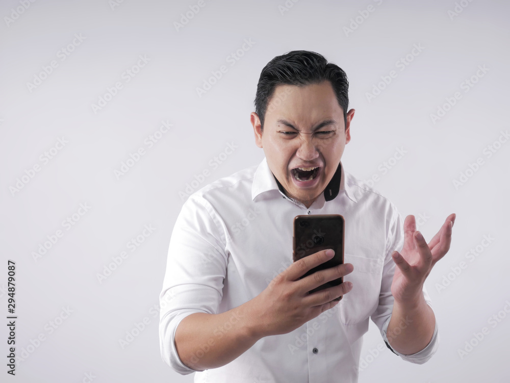 Young Man Getting Bad News on Phone, Shocked and Angry Young Man Getting Bad News on Phone, Shocked and Angry