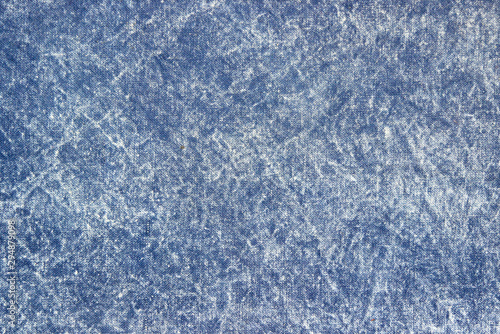 Texture of a blue stone-washed denim fabric