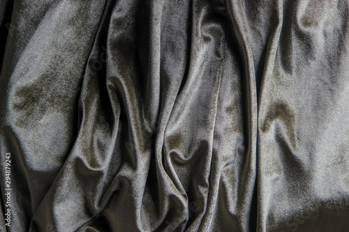 Texture of a wavy surface of a khaki velour fabric as a background
