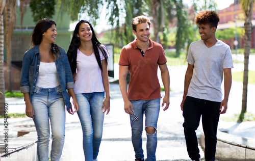 Laughing group of multi ethnic hipster young adults in city