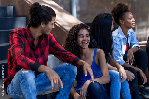 Quadro su tela Laughing group of young latin american and hispanic immigrants in city