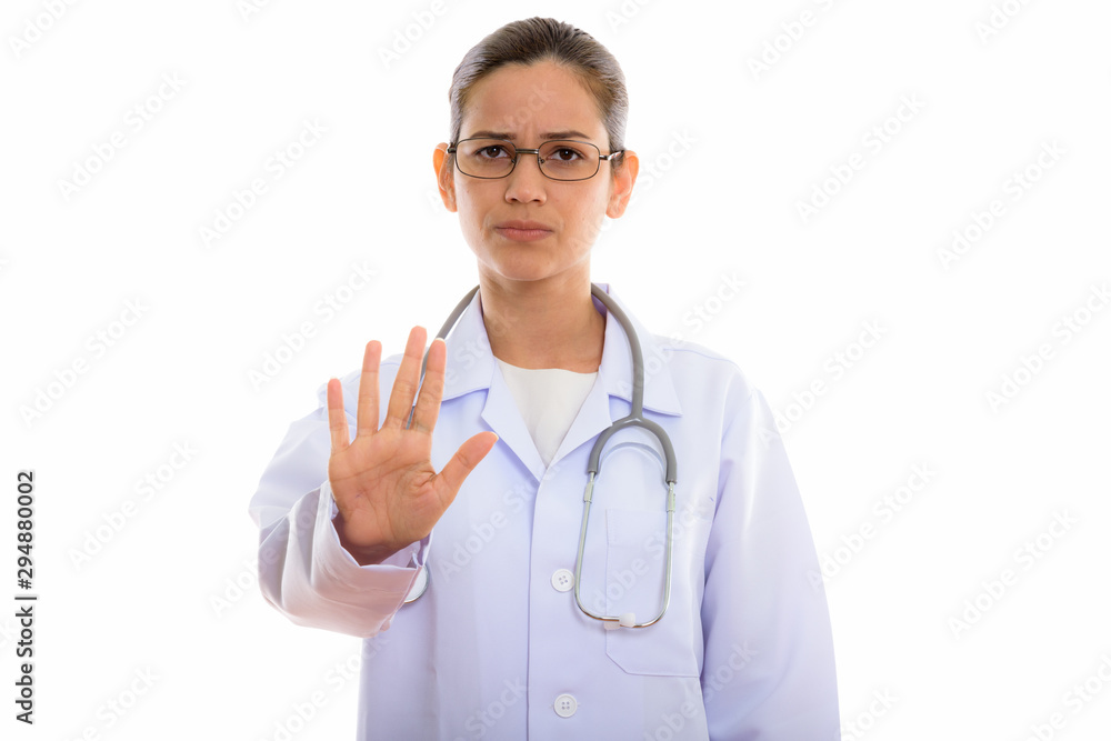 Studio shot of young beautiful woman doctor showing stop hand si Studio shot of young beautiful woman doctor showing stop hand si