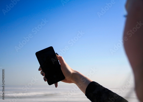 Hand with mobile phone making selfie