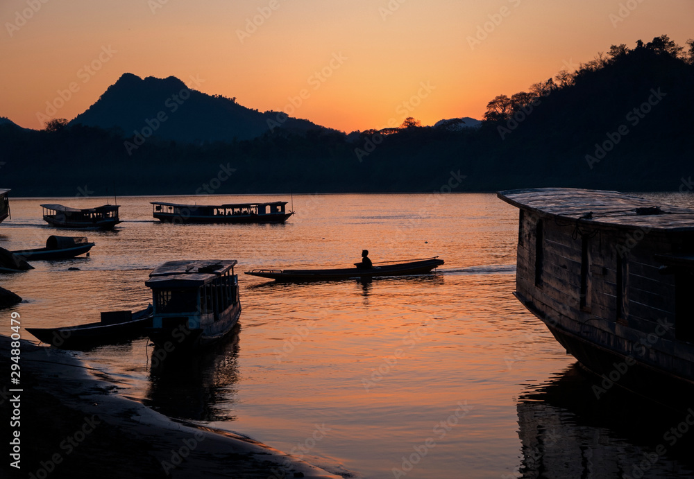 Local ferry boats in the Mekong River at sunset, Luang Prabang, Laos