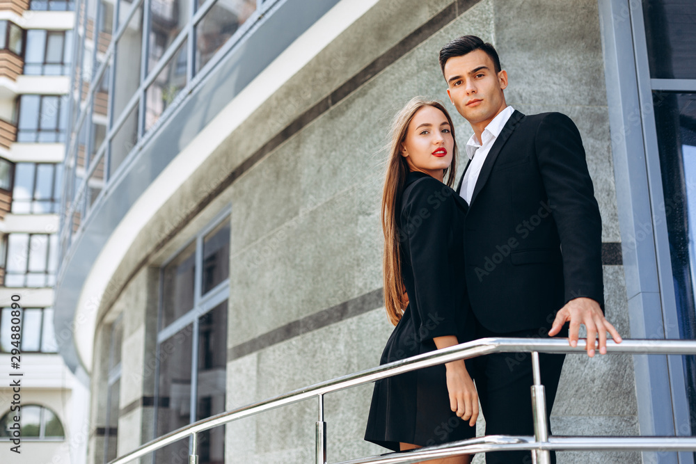 Business partners man and woman standing next a business building.- Image Business partners man and woman standing next a business building.- Image