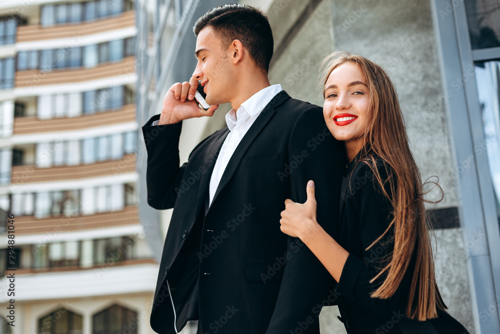 Closeup portrair woman hugging a man who talking a mobile phone.- Image Closeup portrair woman hugging a man who talking a mobile phone.- Image