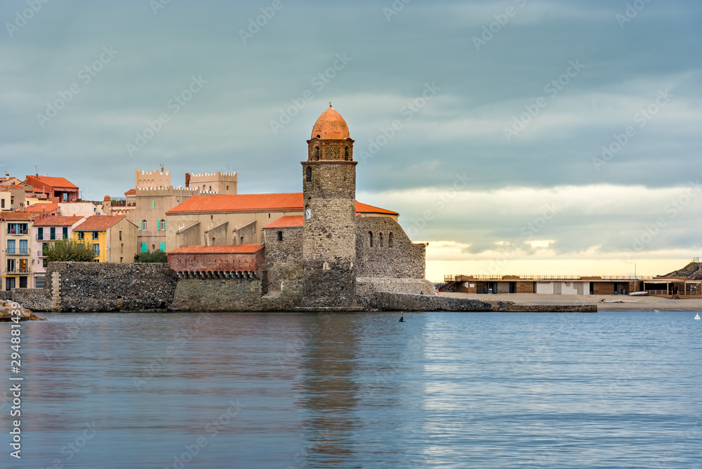 Coliure, France :  2019 Octobre 05 : Beautiful autumn day in the tourist city of Colliure in Occitania whit on back the church of Notre dames des Anges, France.