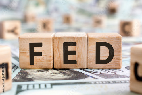 FED - acronym from wooden blocks with letters, abbreviation FED Federal Reserve System or federal agent concept, random letters around, money background photo