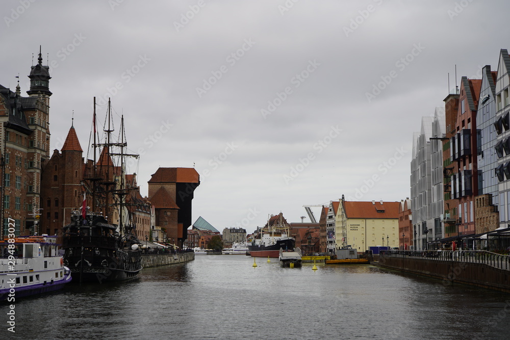 Fototapeta premium Gdansk, Poland - September 2019: A sightseeing ship floats on the river. Excursion ship sailing through the city’s water channels.