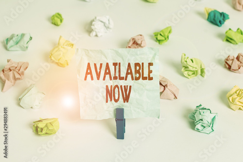Handwriting text Available Now. Conceptual photo Handy Eligible Today Present Bachelor Here on Board Accessible Colored crumpled papers empty reminder white floor background clothespin photo