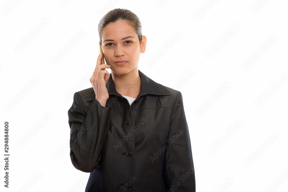 Studio shot of young beautiful businesswoman talking on mobile p Studio shot of young beautiful businesswoman talking on mobile p