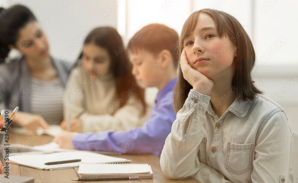 School girl dreaming, not paying attention at lesson School girl dreaming, not paying attention at lesson