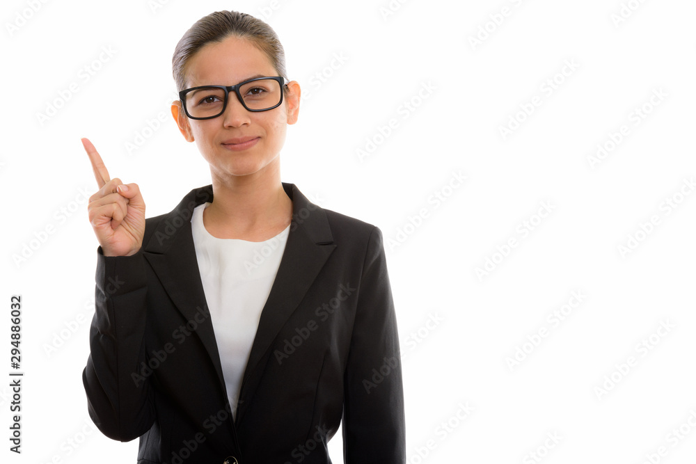 Studio shot of young beautiful businesswoman pointing finger up Studio shot of young beautiful businesswoman pointing finger up