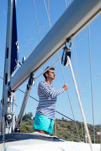Young man on a sailboat © BGStock72