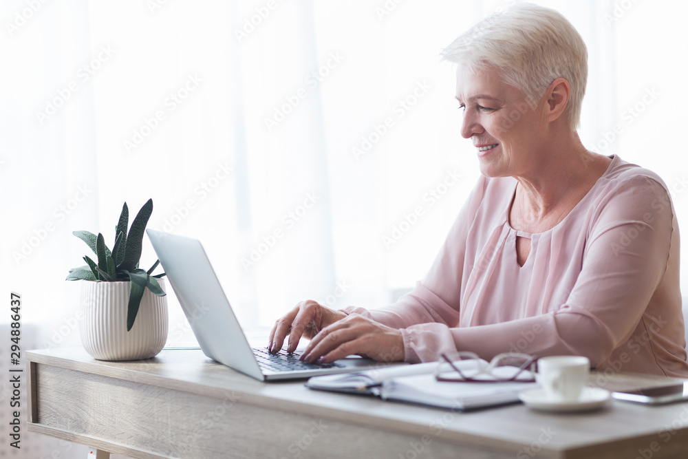 Professional business woman typing email to client Professional business woman typing email to client