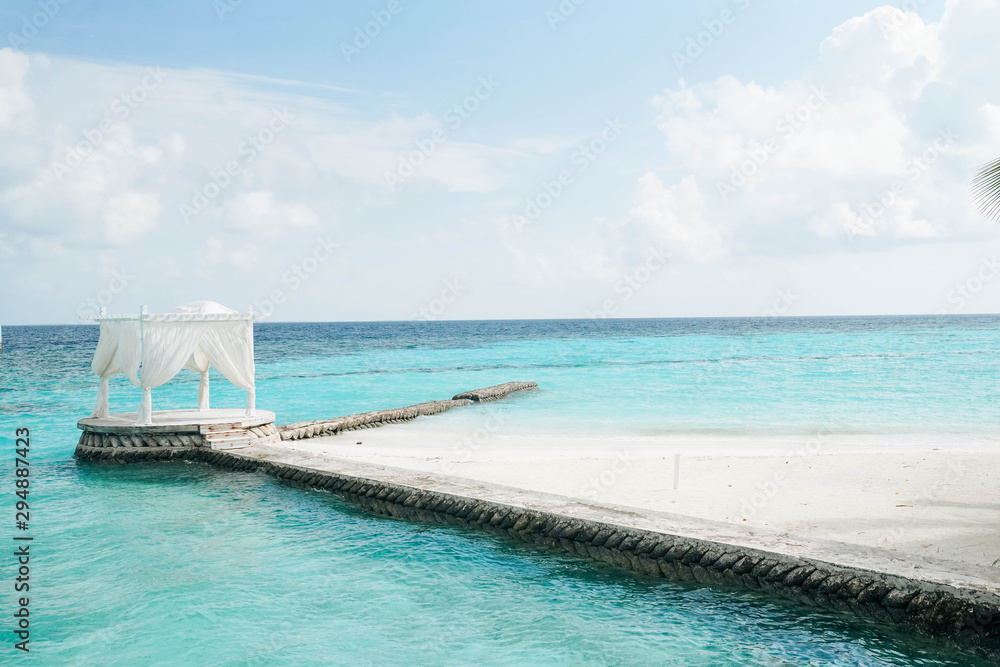 White arch with Beautiful Landscape of Tropical beach summer at resort hotel and spa, Maldives island with sea and sky tranquil for holiday vacation