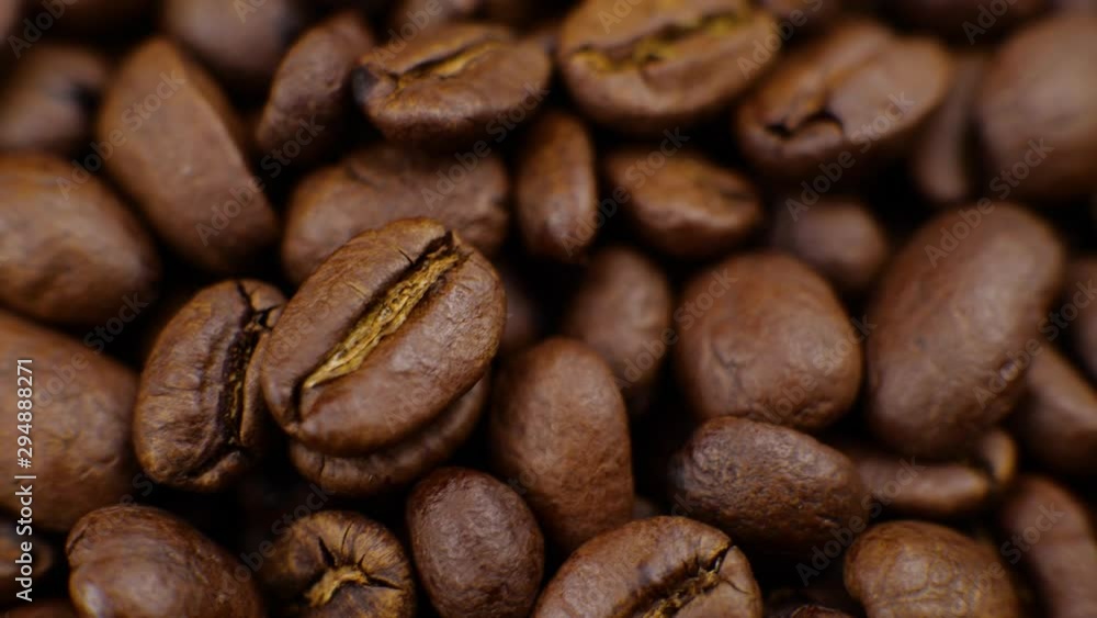 Dark Coffee rotating on board Coffee beans clouse up Beautiful coffee beans. Dark Coffee rotating on board Coffee beans clouse up Beautiful coffee beans.