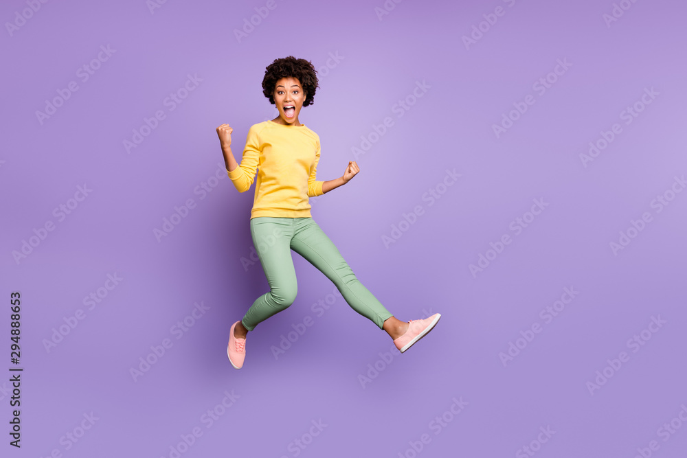 Full size photo of crazy brunette hair girl hear incredible fall spring lottery victory feel impressed jump raise fists scream yeah wear casual style outfit isolated violet color background