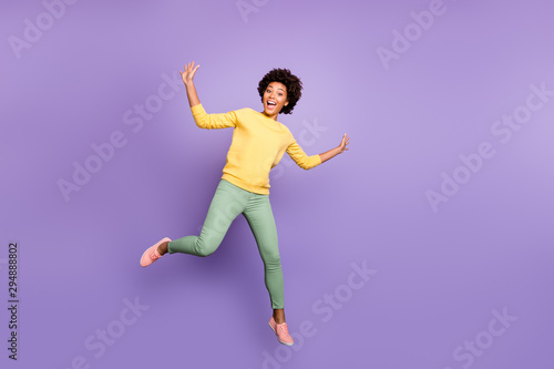 Full length photo of amazed excited teenager girl have fun autumn fall holidays greet friends feel crazy like child jump scream wear casual style outfit isolated violet purple color background