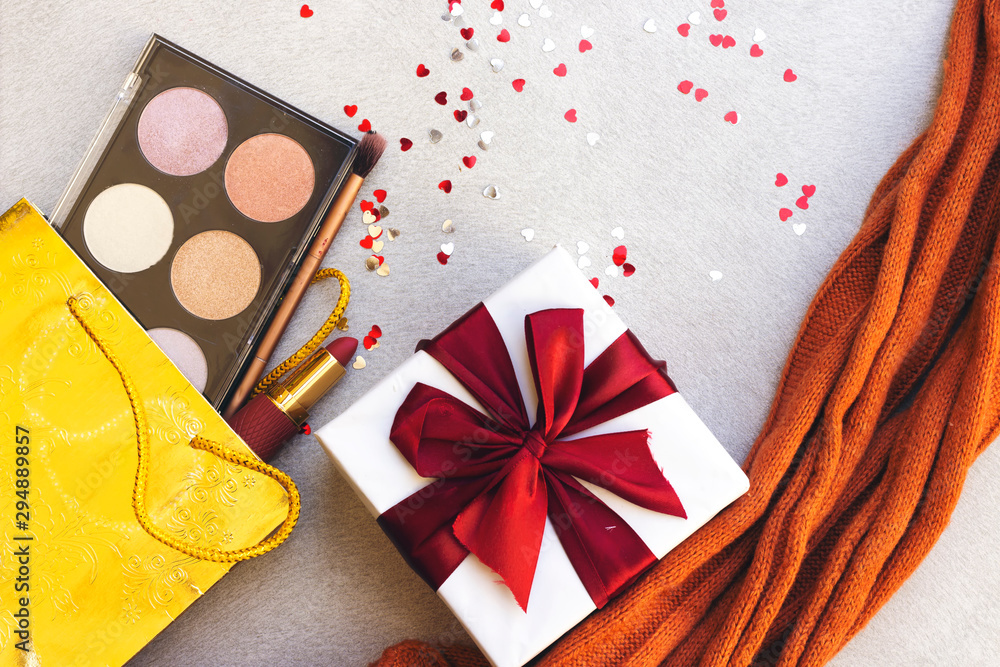box of highlighter and glitter and lipstick, brush on gift bag, gift box and heart confetti with orange scarf box of highlighter and glitter and lipstick, brush on gift bag, gift box and heart confetti with orange scarf