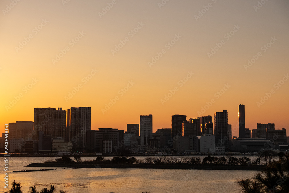 landscape golden sunset light with shadow of city tower  and  front of river 
